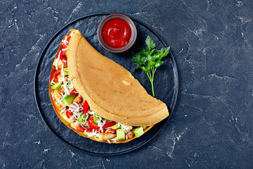 Thick asian pancake of avocado, chicken, flat lay