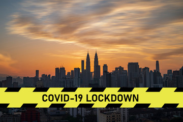 city scape with large covid-19 lockdown sign