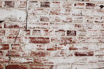photo of an old brick wall covered with white paint