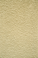 Yellow painted plaster on wall