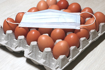 a medical dressing lies on brown eggs, against a light tree. Endangered Easter, Home Holidays,...
