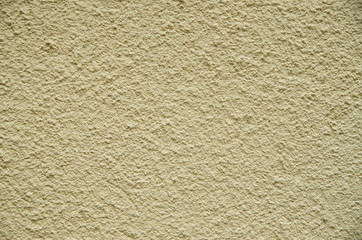 Yellow painted plaster on wall