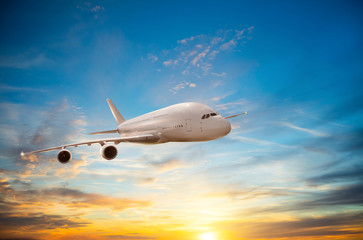Naklejka na ściany i meble Passengers commercial airplane flying in sunset