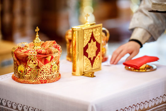 bible and golden crown of newlyweds in the church