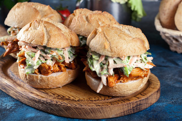 Pulled chicken sandwich with salad and bbq sauce