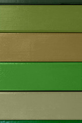vertical background. multi-colored boards in green and ocher colors are horizontally arranged