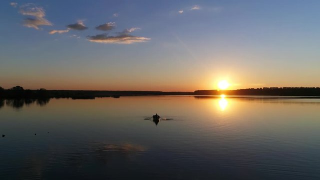 People in the Rowing Boat. Sunset on a Lake or River - Drone Footage