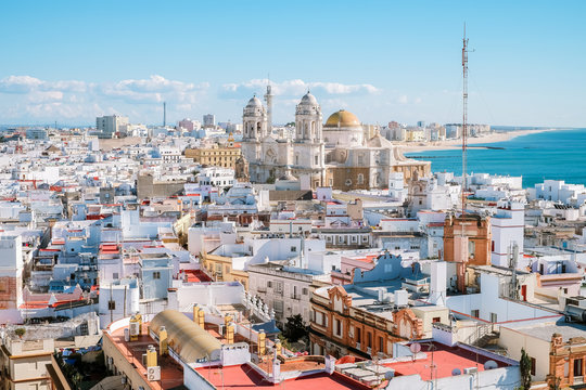 Aerial panoramic view of the old city rooftops and Cathedral de Santa Cruz in the afternoon from tower Tavira in Cadiz, Andalusia, Spain