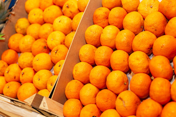 Boxes of juicy tangerines on a store counter. Close-up.