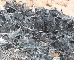 Pile of used black plastic baskets from the market in nature. Concept of environment and plastic waste. Georgia. 2020