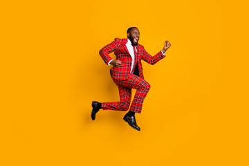Fototapeta na wymiar Full body profile photo of crazy dark skin guy jump high up celebrate achievement scream loud wear plaid red costume blazer pants shoes isolated bright yellow color background