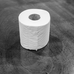 Toilet paper on wooden table in black and white