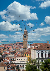 Fototapeta na wymiar Tile rooftops and church domes across Venice skyline