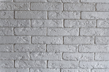 Interior brickwork of white decorative plaster brick on the wall. Loft style interior design.