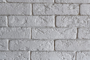 Interior brickwork of white decorative plaster brick on the wall. Loft style interior design.
