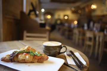 breakfast in a French cafe / croissant with salmon and salad for breakfast in a restaurant