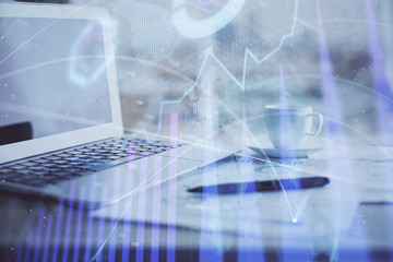 Forex graph hologram on table with computer background. Double exposure. Concept of financial markets.