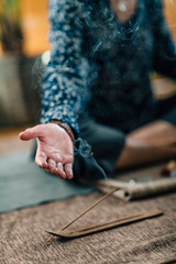 Mindful Woman Practicing Daily Meditation with Incense Sticks Burning