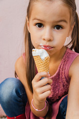 Concept of national ice cream day. Girl with brown eyes holds an ice cream in a waffle cup