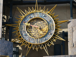 Photography of clock face on the city street in spring day time. Concepts of life and it will pass.