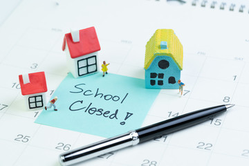 Social distancing school closed to stop and protect from COVID-19 Coronavirus outbreak, miniature kids stay at home, small houses with sticky note on calendar written School Closed