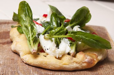Tasty vegetarian pizza with mozzarella cheese and spinach