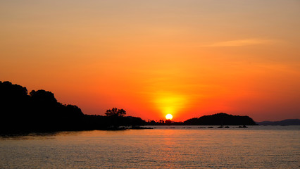 Fototapeta premium Silhouette mountain and sea view with sunset sky background.