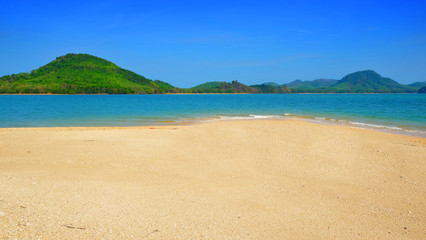 Fototapeta na wymiar Clear sand beach form tropical island view background on summer season.
