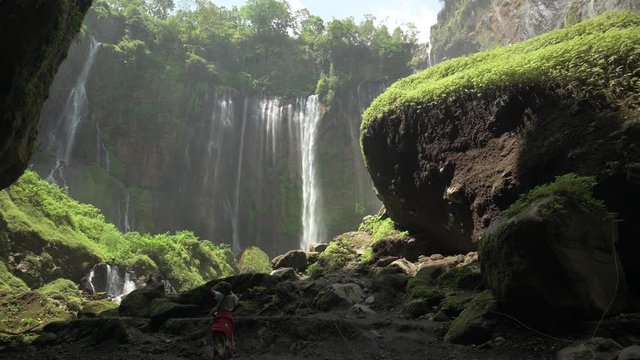 Stunning view of the Tumpak Sewu Waterfalls also known as Coban Sewu. Tumpak Sewu Waterfalls are a tourist attraction in East Java, Indonesia.