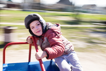 Fototapeta na wymiar Boy happy riding carousel