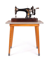 Antique, vintage sewing machine on an old table
