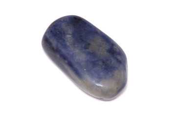 A blue gemstone photographed against a white background
