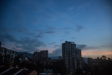 Fototapeta na wymiar Night falls over the skyscraper apartments of the affluent barrio of El Poblado in the city of Medellin, Colombia