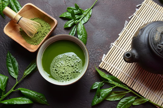 Green matcha tea drink and tea accessories on white background. Japanese tea ceremony concept. Detox tea. Antioxsidant drink