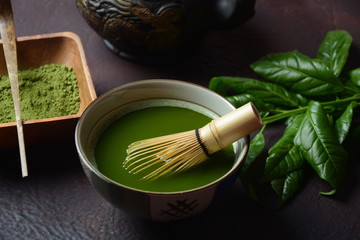 Green matcha tea drink and tea accessories on white background. Japanese tea ceremony concept. Detox tea. Antioxsidant drink