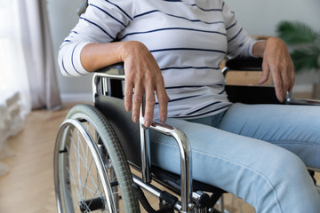 Close up of handicapped senior woman sit in wheelchair feel lonely abandoned in hospital, old lady...