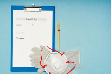 Coronavirus, covid-19. Coronavirus test results on a blank, blue background. Protective mask and...