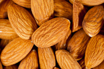 Almonds nuts shot large on a wooden background. Background for healthy eating and vegetarianism.