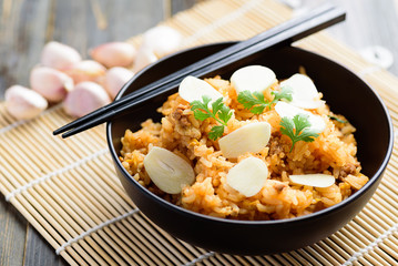 Fried rice with minced pork and fresh garlic in a bowl with chopsticks, Asian food
