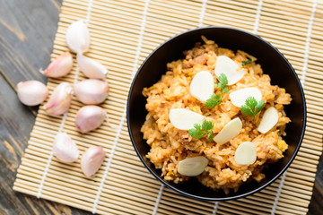 Fried rice with minced pork and fresh garlic in a bowl, Asian food, Top view