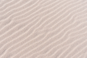 Fototapeta na wymiar Waves of sand on the beach