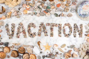 inscription vacation with stones and shells lying on a marble background, composition of sea stones and seashells, word vacation written by stones, vacation word written with stones