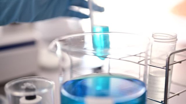 試験チューブを持つ手元・科学実験