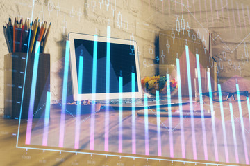 Double exposure of graph and financial info and work space with computer background. Concept of international online trading.