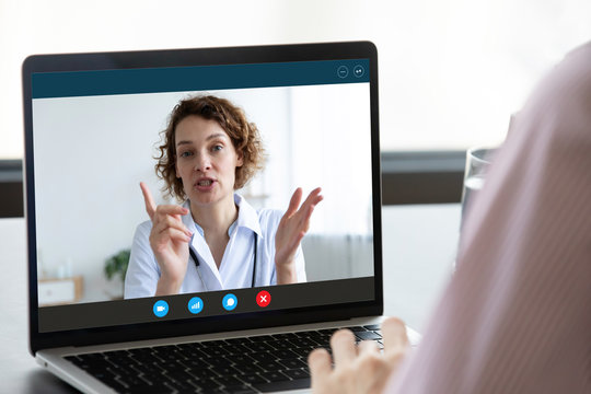 Close up of patient talk on video call with female doctor or nurse with internet wireless communication, person speak consult online with physician using virtual webcam conference on computer