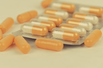 Assorted pharmaceutical medicine pills and capsules. Pills background. Heap of assorted various medicine tablets and pills different colors on white background. Health care. Copy space.