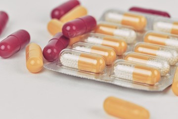 Assorted pharmaceutical medicine pills and capsules. Pills background. Heap of assorted various medicine tablets and pills different colors on white background. Health care. Copy space.