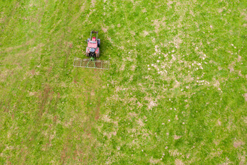 a farming machine from above on a green meadow