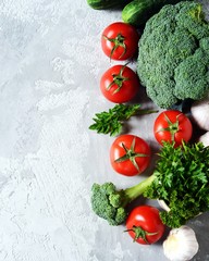 Fresh vegetables: tomatoes, broccoli, cucumbers and garlic. Healthy eating concept. Copy space