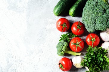 Fresh vegetables: tomatoes, broccoli, cucumbers and garlic. Healthy eating concept. Copy space